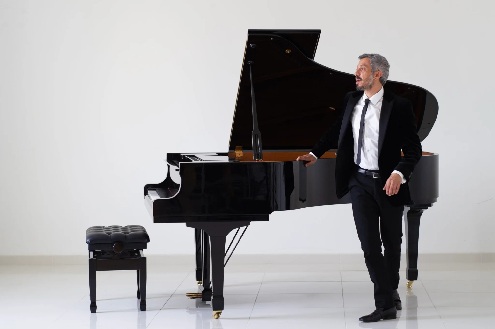 Rami Sarieddine beside a grand piano